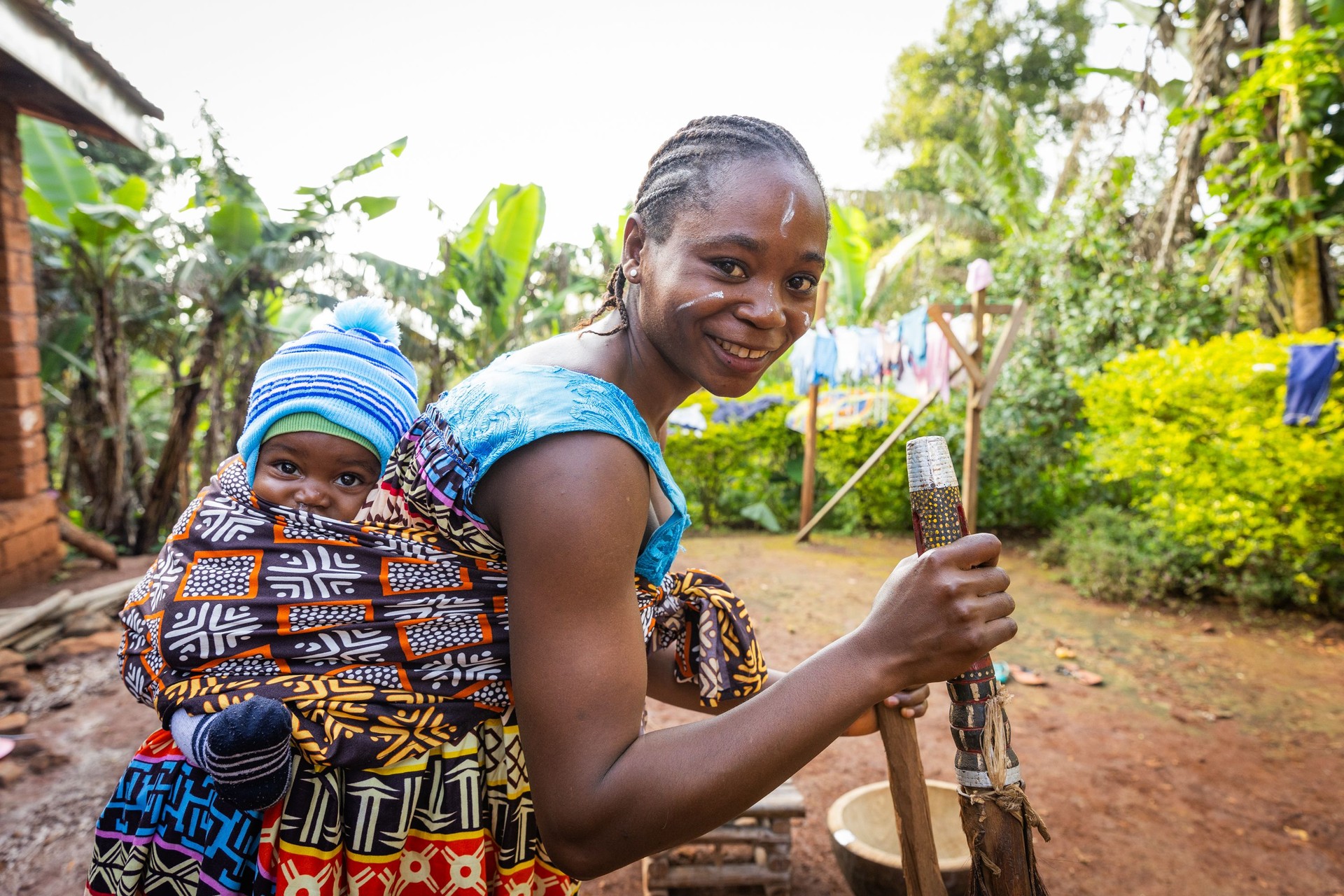 An African mother with her newborn son in the village, African tribal clothing